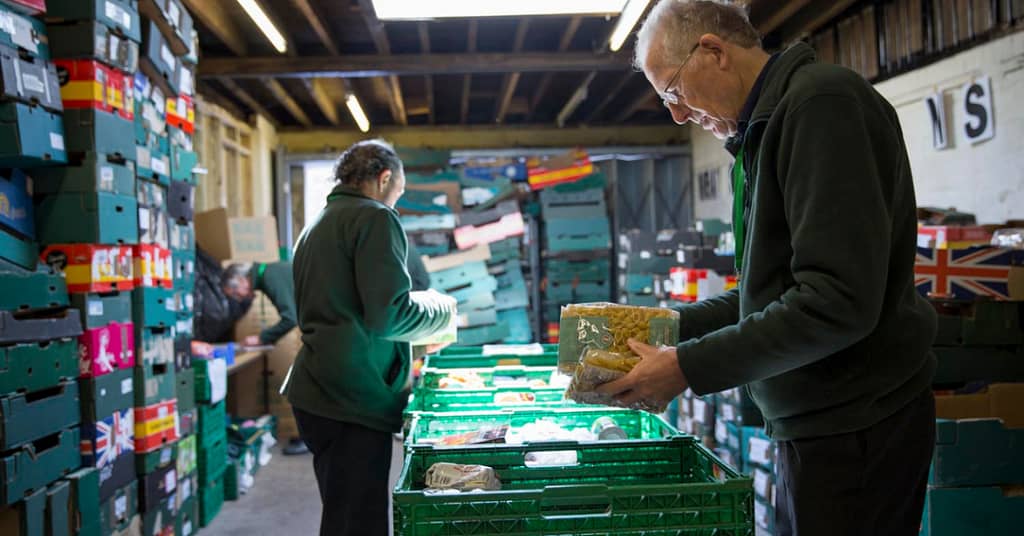 2 staff working in a food bank.