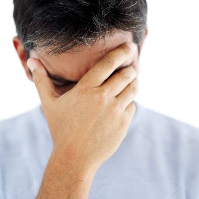 Young man head in hands showing pity.